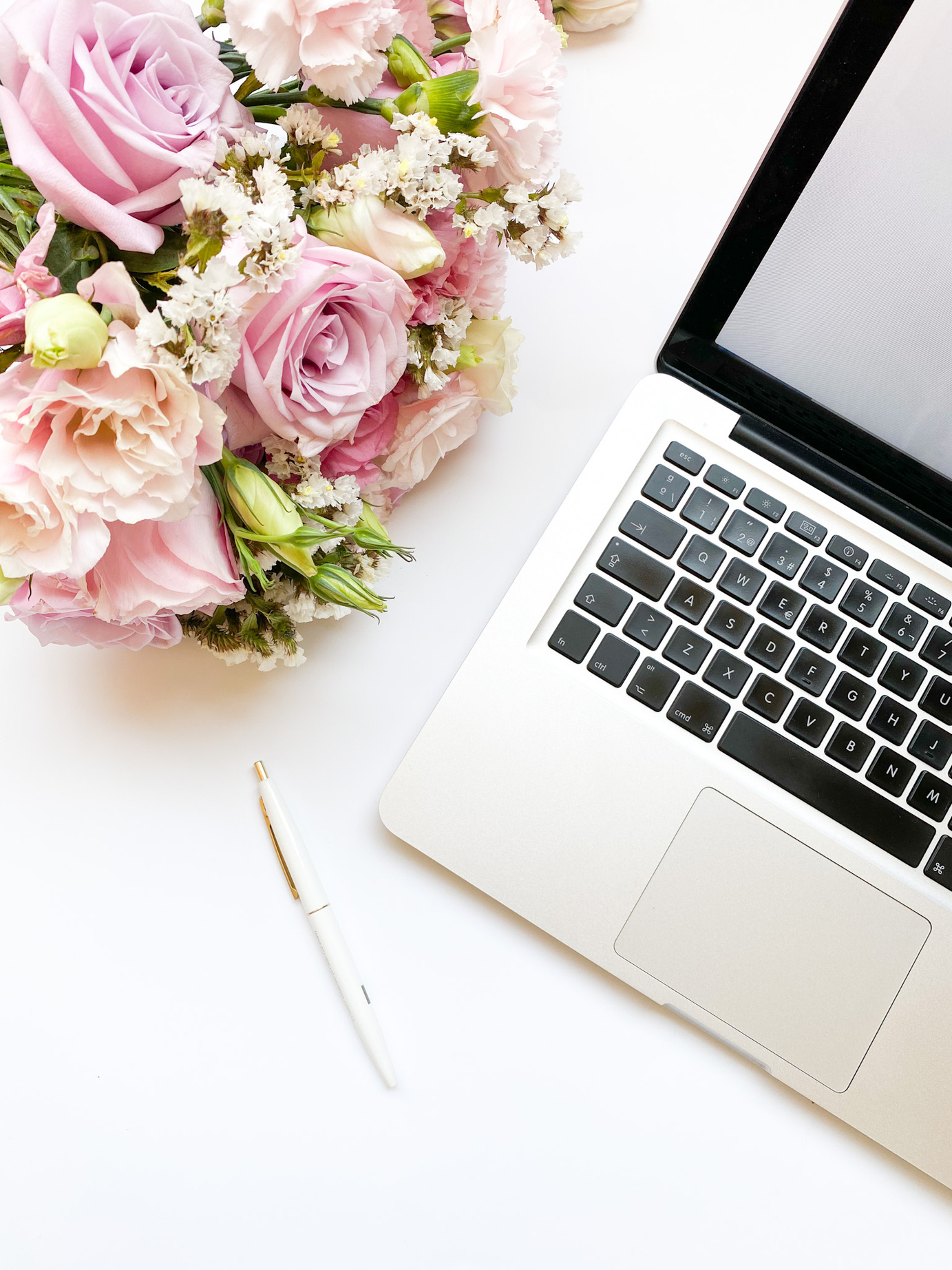 Flatlay of Laptop and Bouquet of Flowers